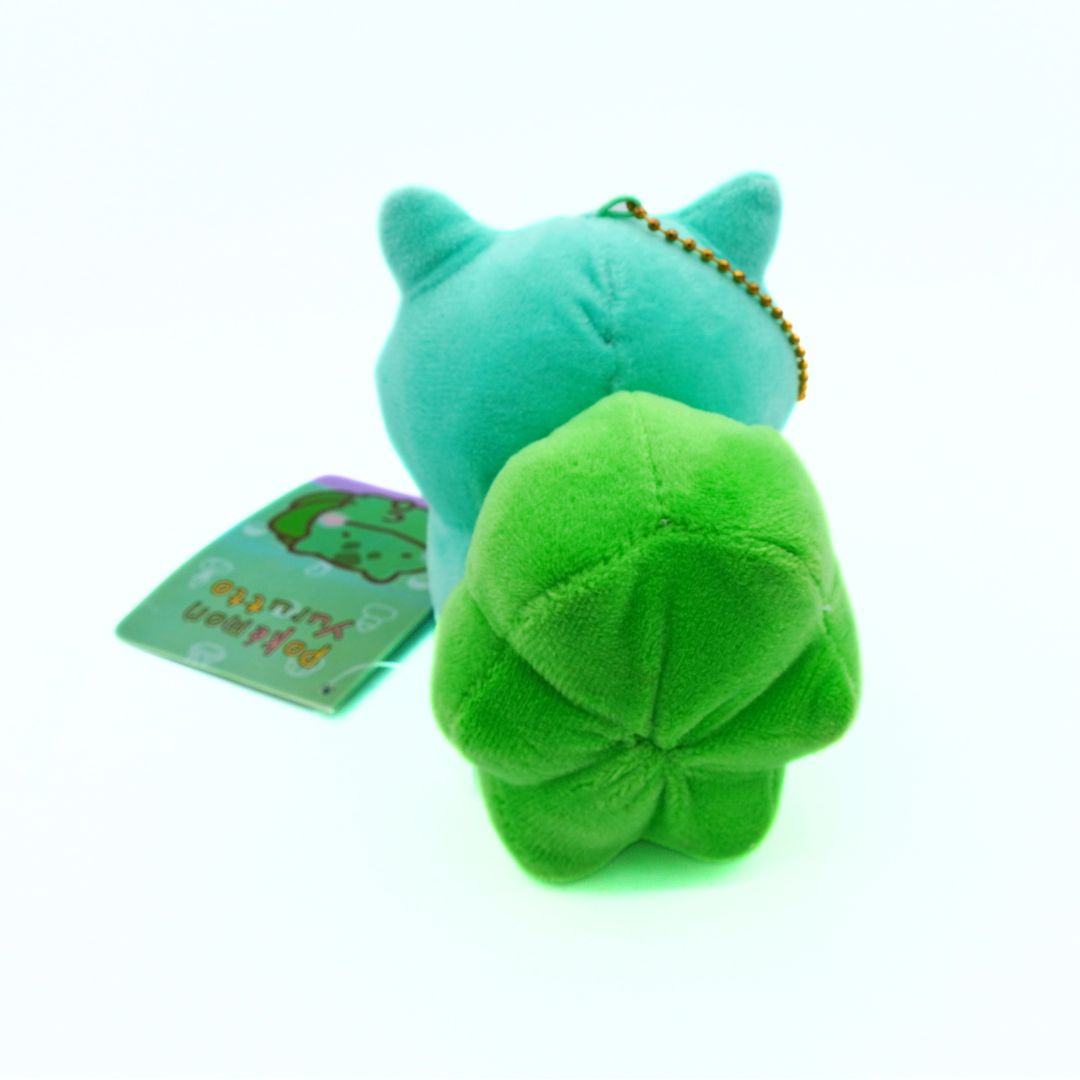 Green plush keychain with a tag on a white background