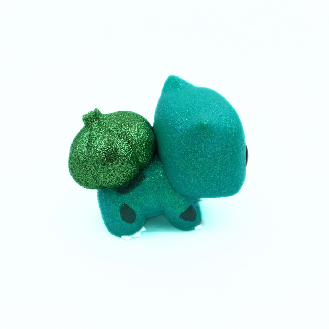 Green vinyl toy with a large head on a white background