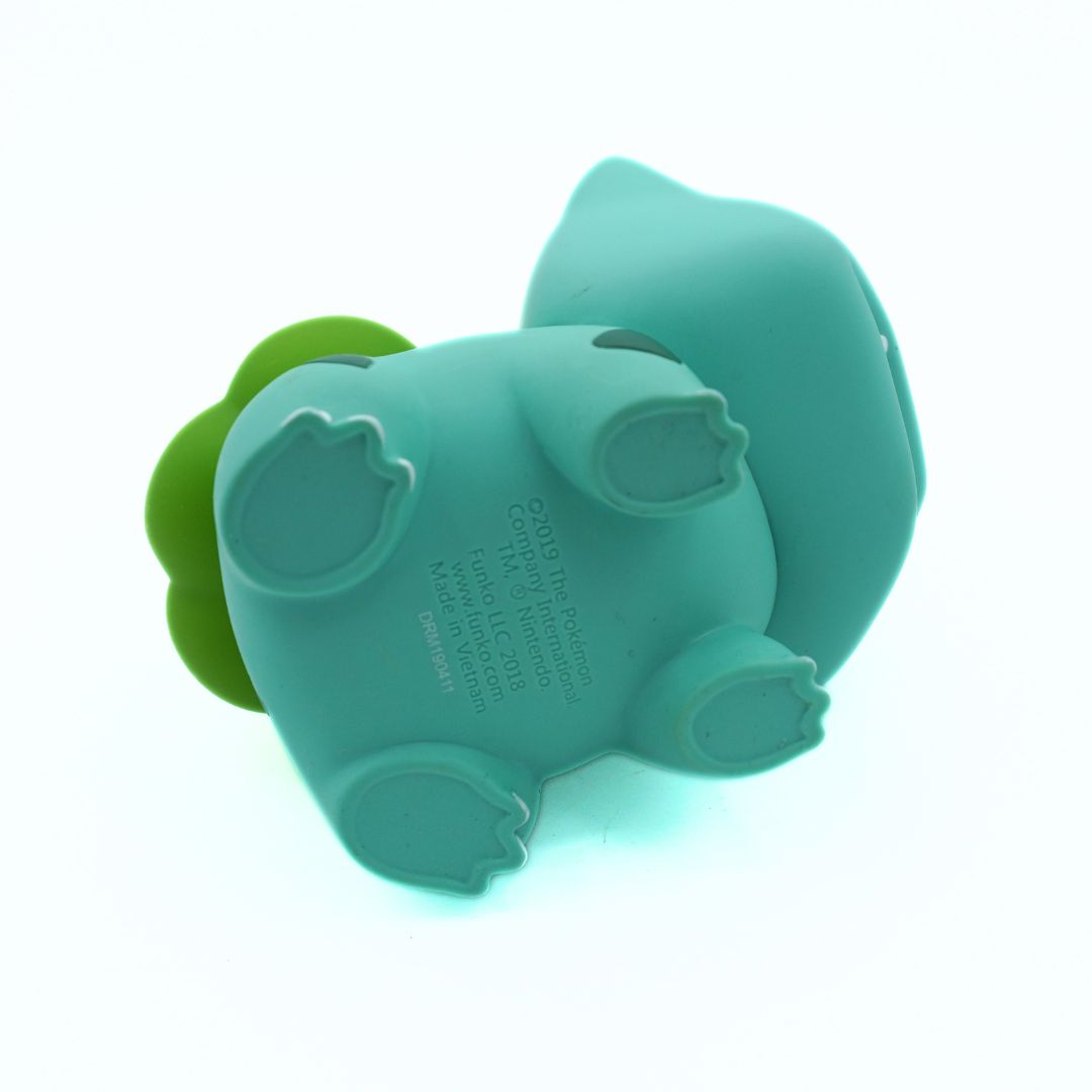 Teal silicone mold shaped like a flower on a white background