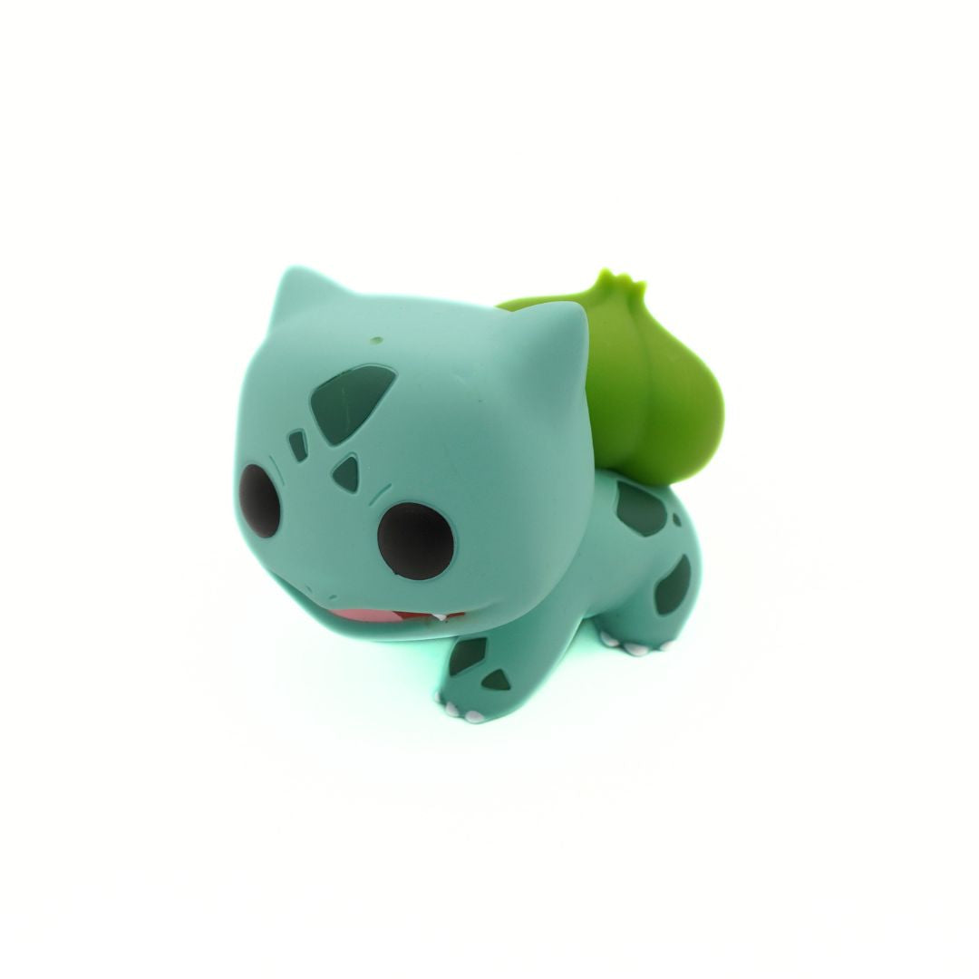 Green cartoon character with a leaf on a white background