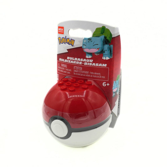 Mega Bloks Bulbasaur building toy set in its original retail packaging, featuring a red and white spherical toy with a gray band and studs on top, next to a red and white card backing with a blue Bulbasaur illustration.