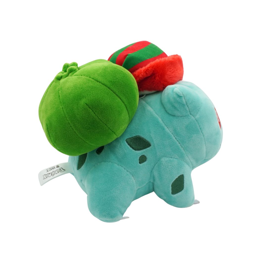 Plush toy resembling a dinosaur with a green shell and red and green top on a white background