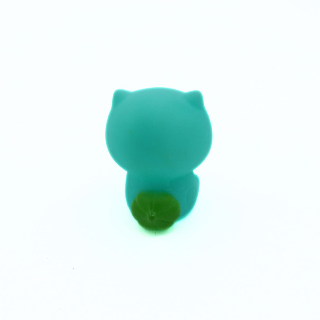 Turquoise cat-shaped object on a white background