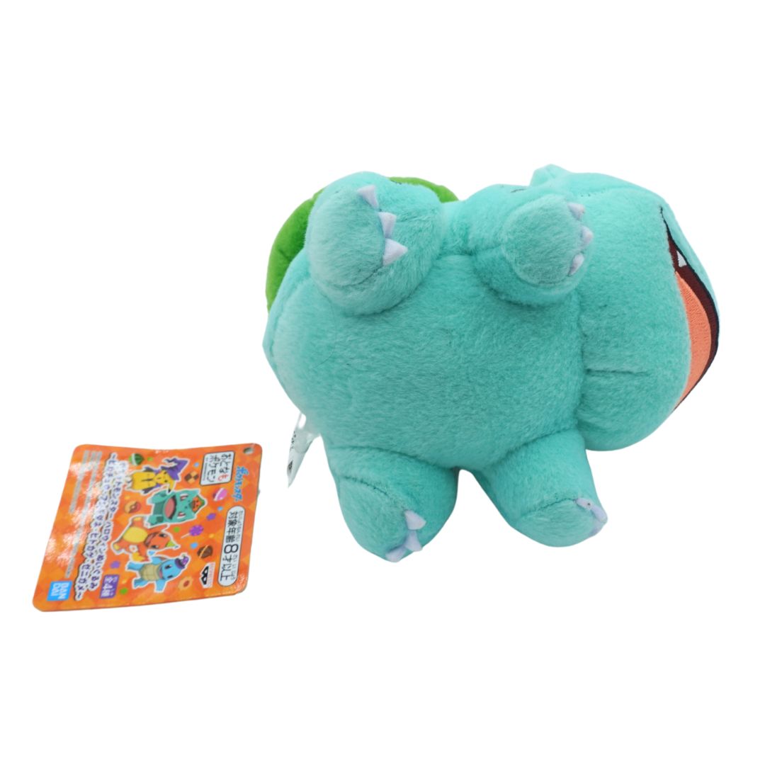 Green plush toy with a small card on a white background