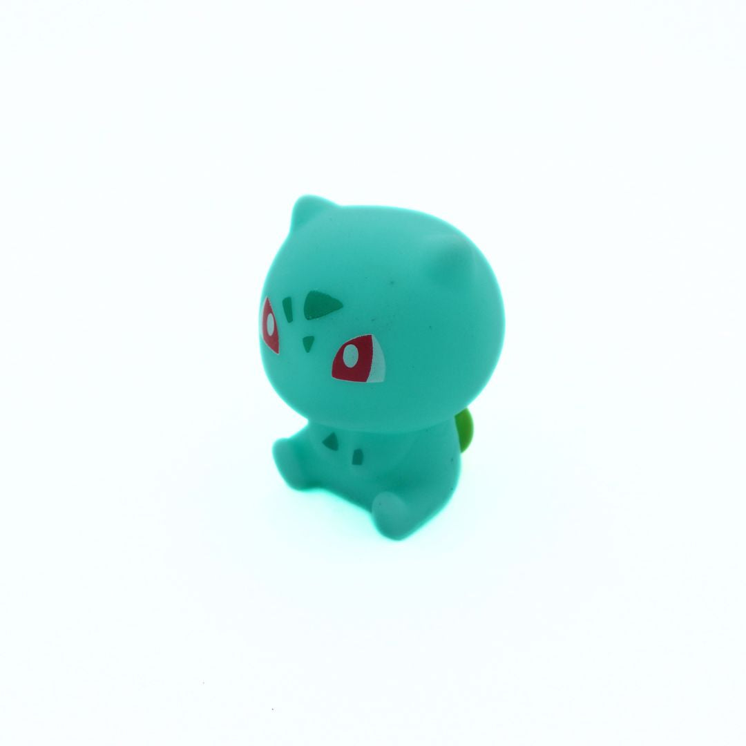 Small green plush toy on a white background