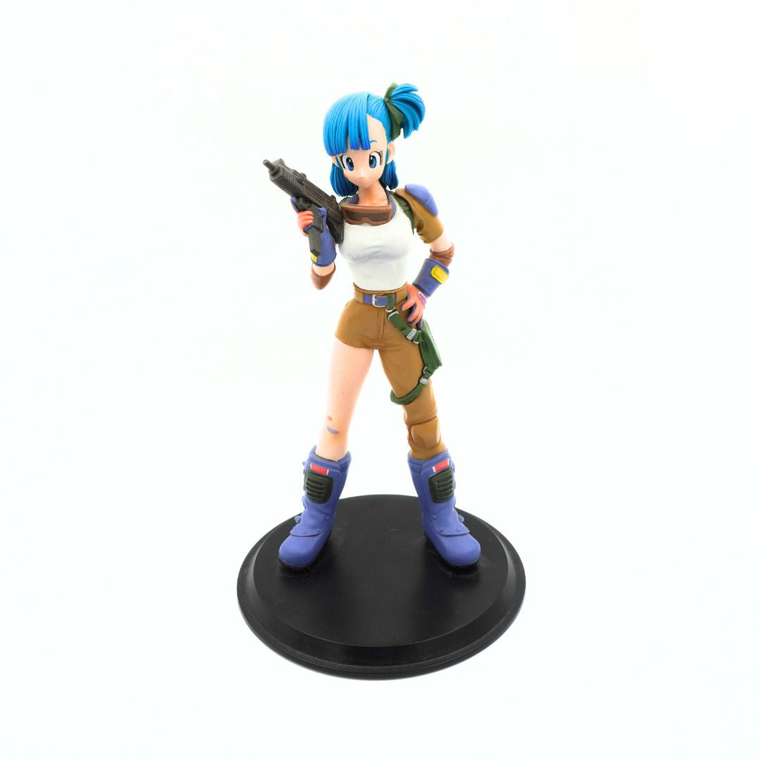 A collectible anime figurine of a female character with bright blue hair, wearing a white tank top, brown shorts, and blue boots, holding a gun and standing on a round black base against a white background.