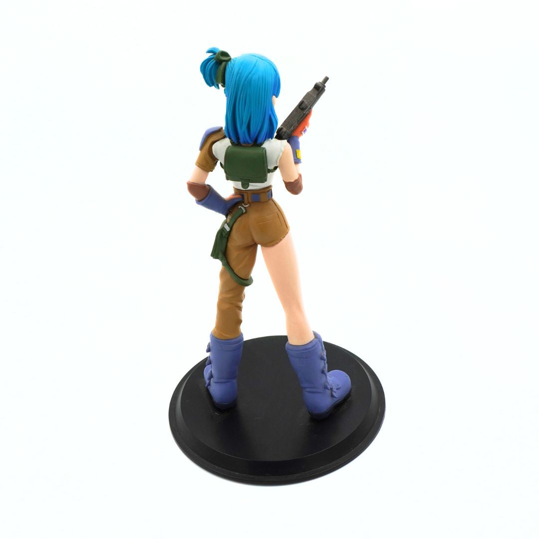 A collectible anime figurine of a female character with bright blue hair, viewed from behind as she holds a gun, standing on a round black base against a white background.