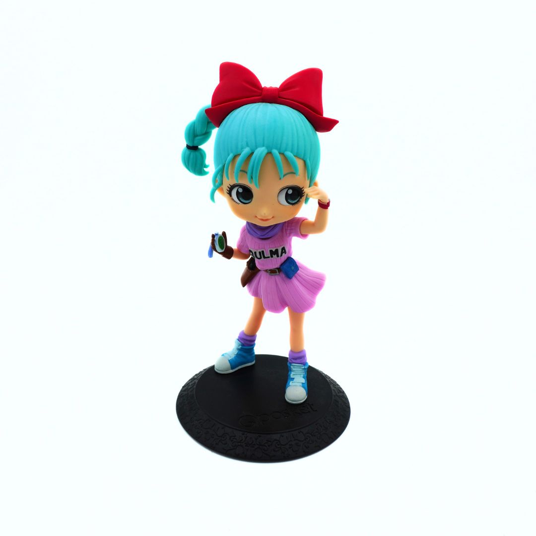 A small anime-style figurine of a girl with bright turquoise hair, a large red bow, and a pink outfit, standing on a round black display base against a plain white background.