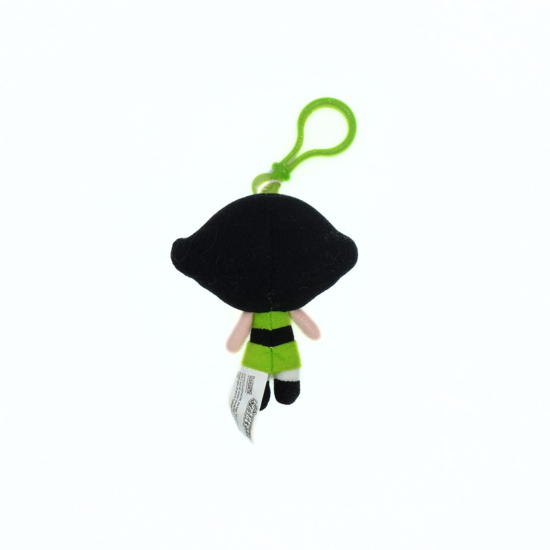 Plush keychain with a black hair and green outfit on a white background