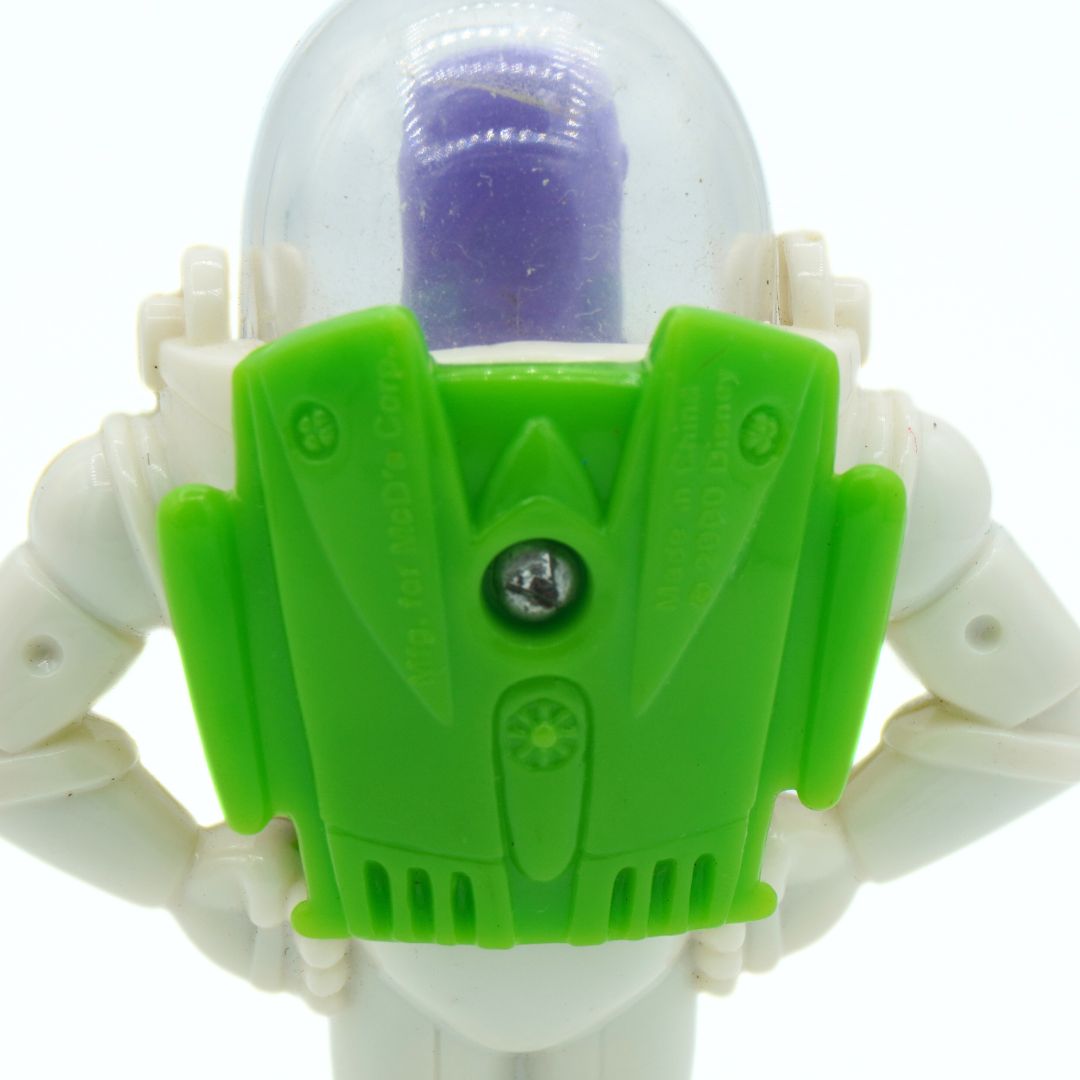 Toy figure with a green chest piece and white arms on a white background