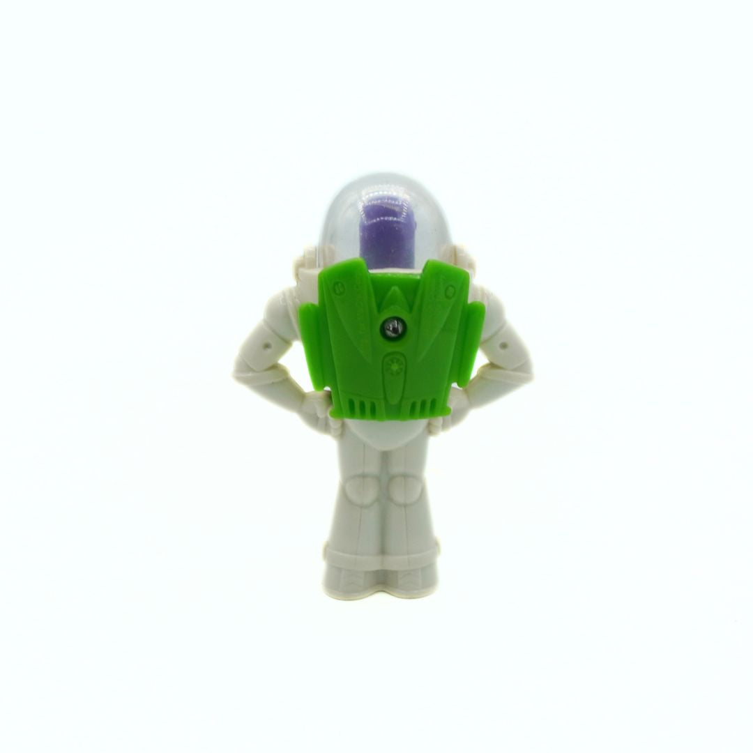 Toy figure with a green and purple object on a white background