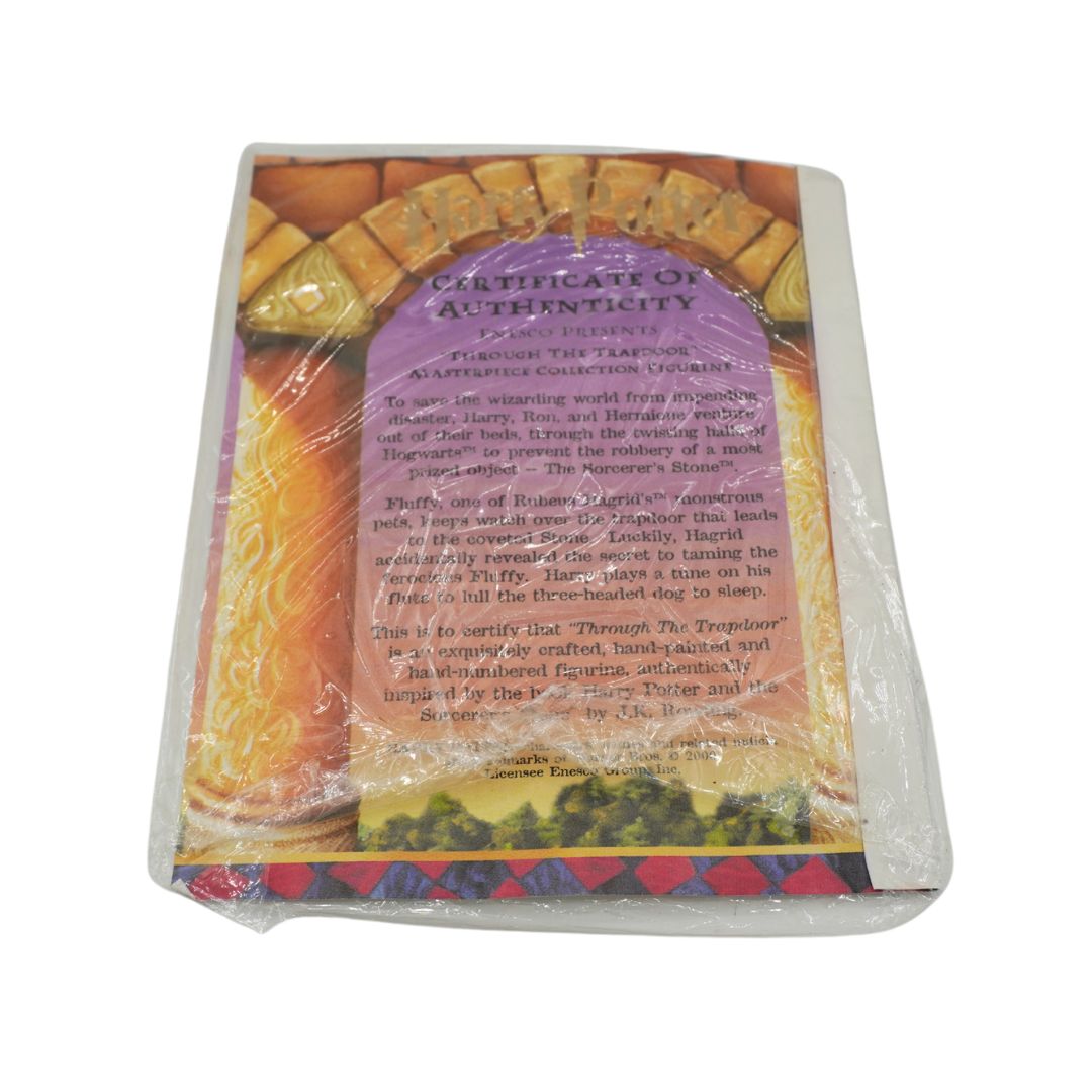A square decorative tile or coaster wrapped in clear plastic, featuring a Certificate of Authenticity label over a purple and orange background with a floral border.