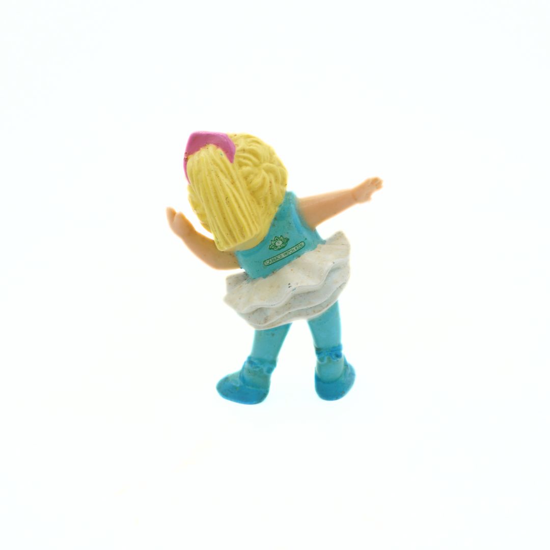 Toy figure with blonde hair and blue outfit on a white background