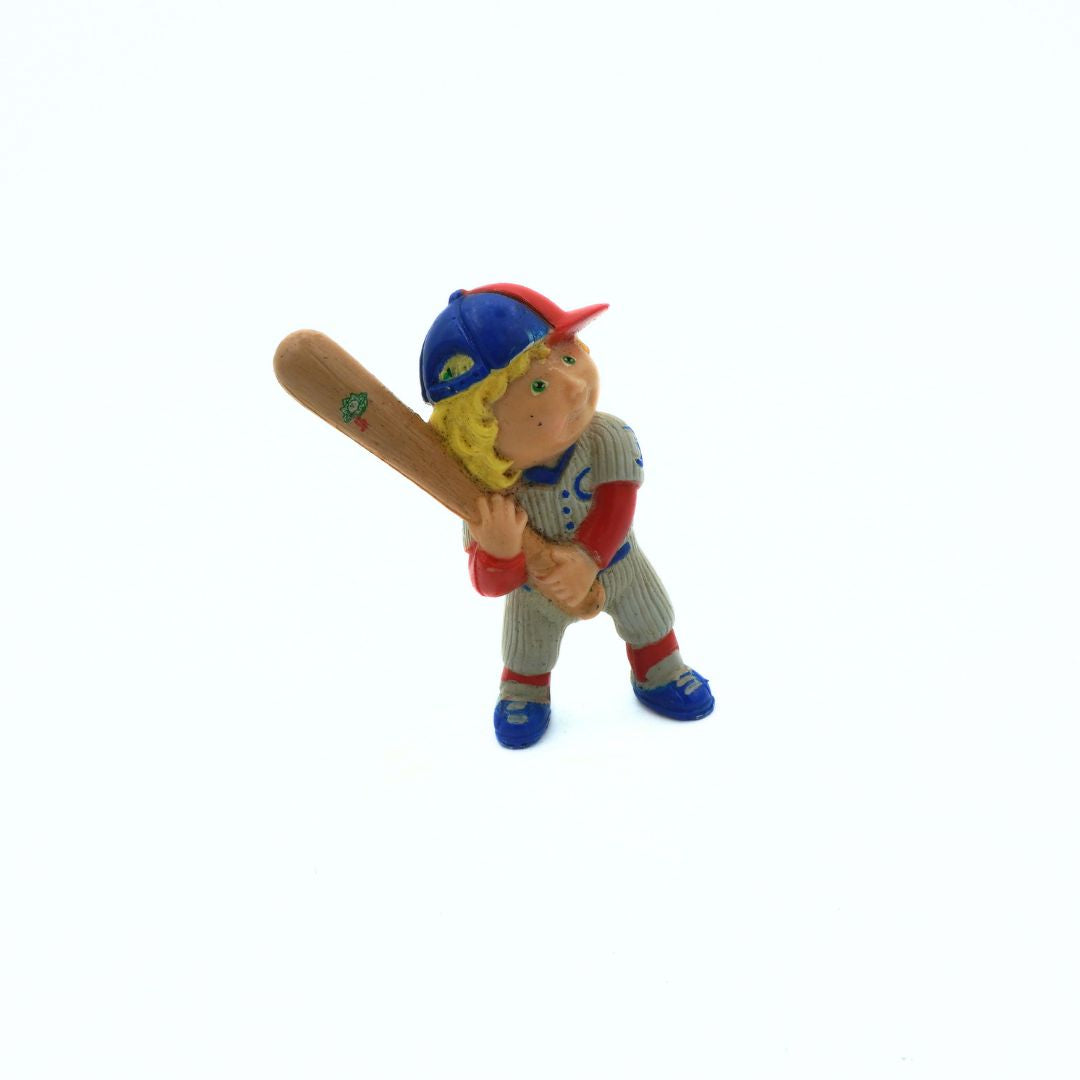 Toy figure of a baseball player holding a bat on a white background