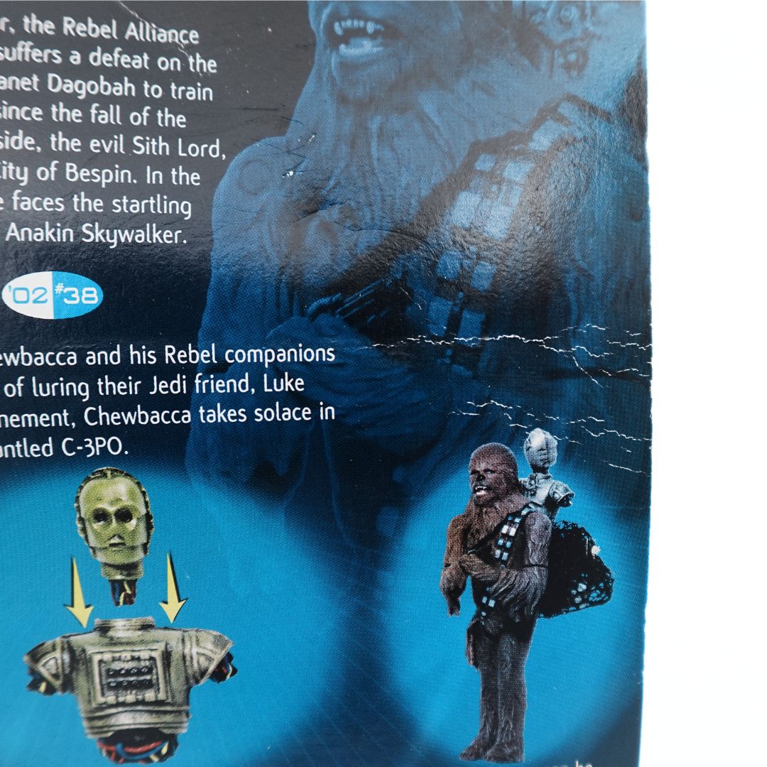 Close up of crease lines on the blue cardback from the 2002 Chewbacca Cloud City Capture figurine