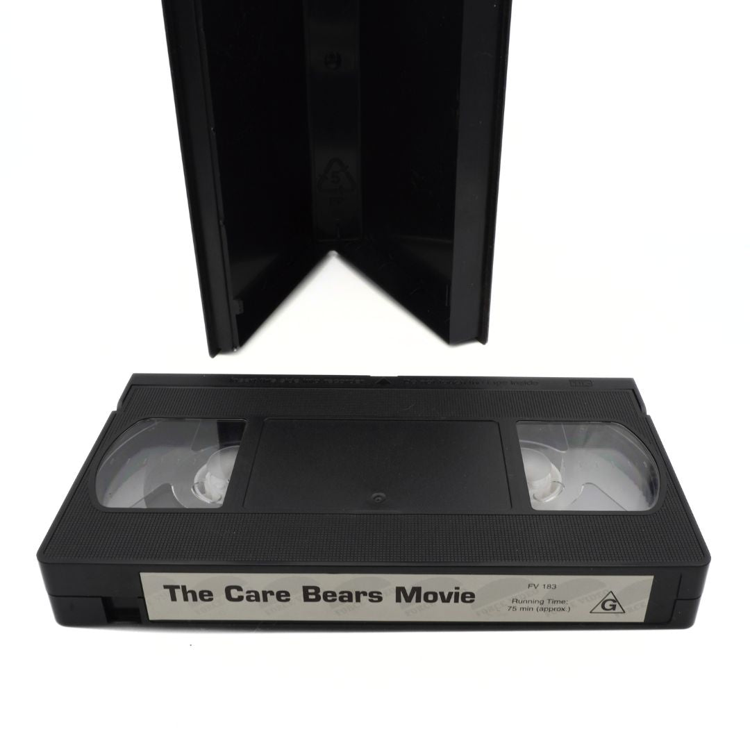 VHS tape of 'The Care Bears Movie' with open black case on a white background