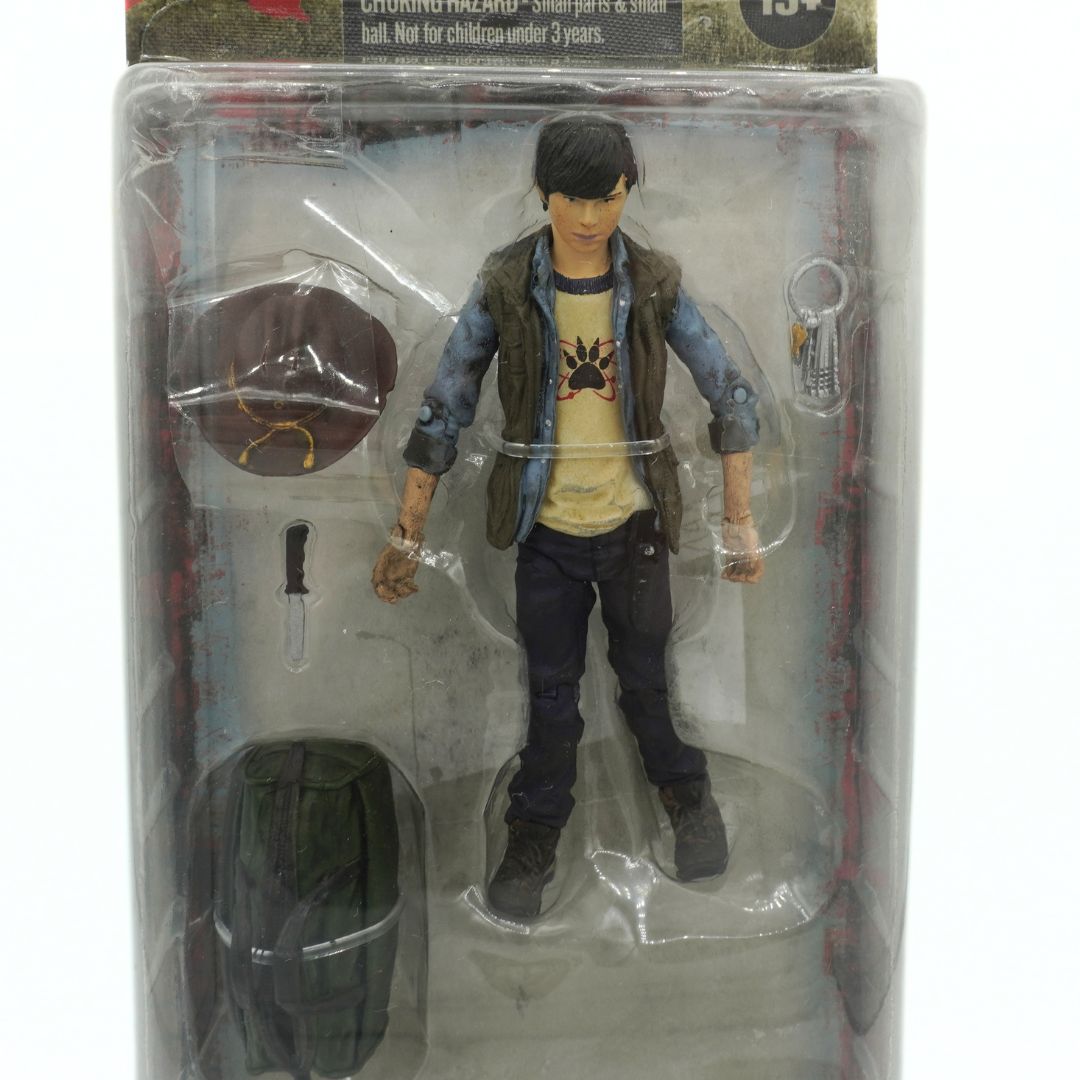 Action figure in packaging with accessories on a white background