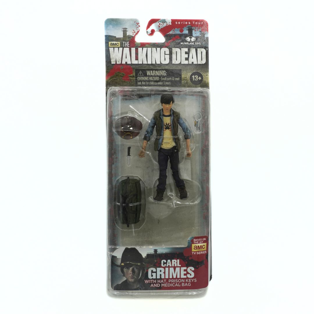 Action figure of Carl Grimes from 'The Walking Dead' series in packaging on a white background