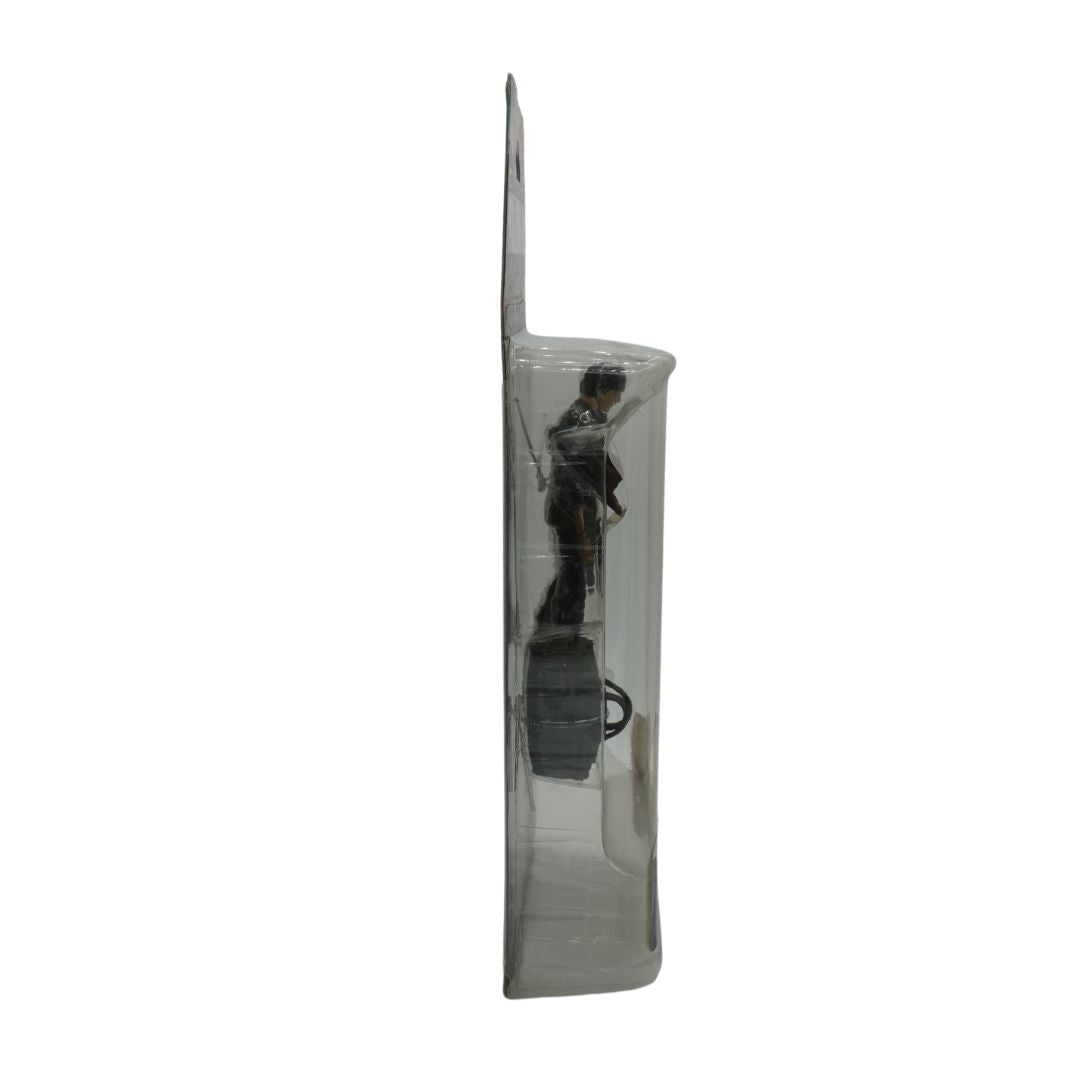 Clear plastic packaging with a figurine inside on a white background