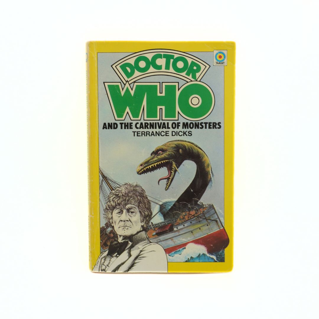 Book cover of 'Doctor Who and the Carnival of Monsters' by Terrance Dicks with a yellow border.