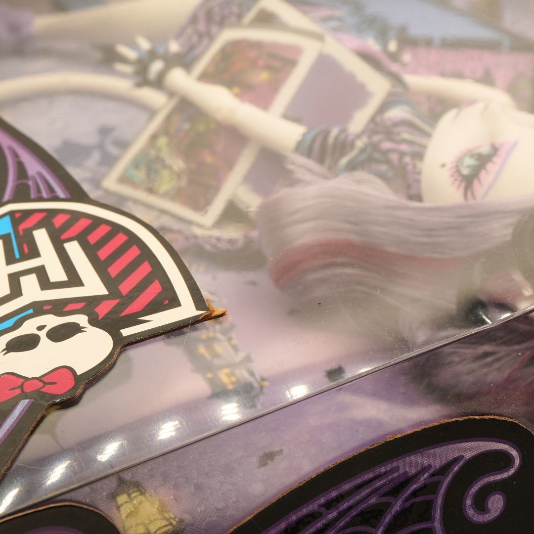 Close-up of a colorful card with a character design on a reflective surface.