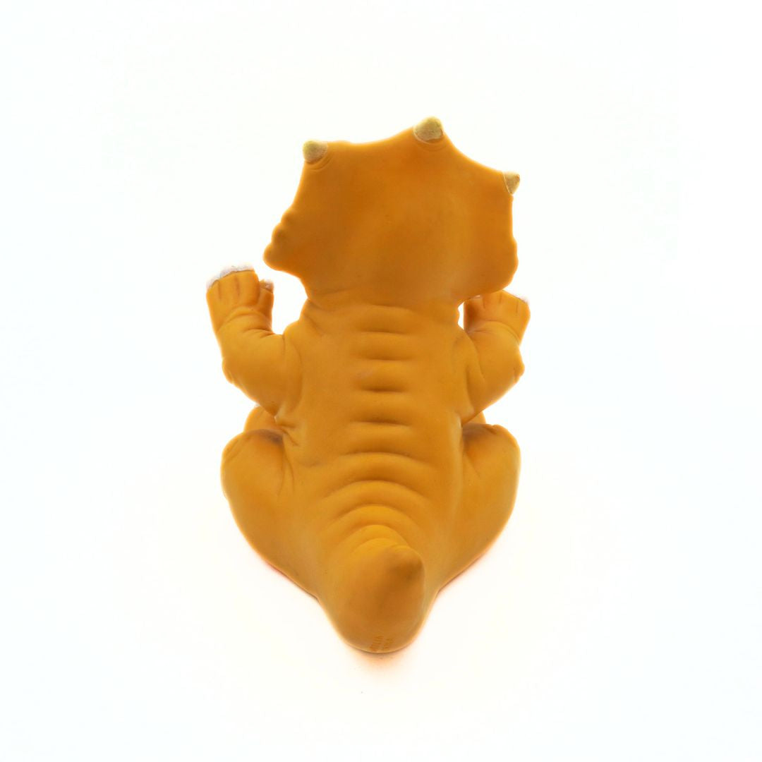 Yellow dinosaur-shaped object on a white background