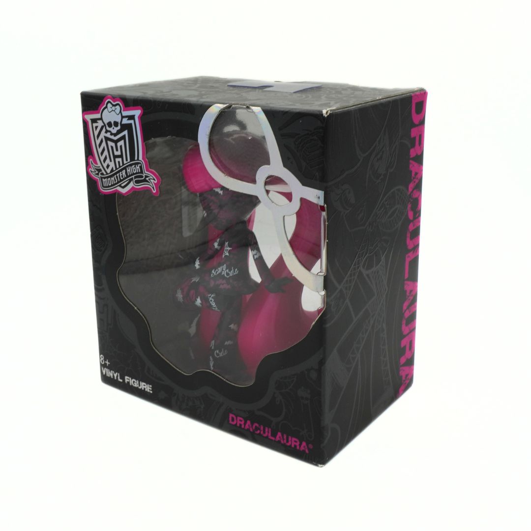 Boxed vinyl figure of a character with pink hair, featuring the brand 'Monster High' on a white background.