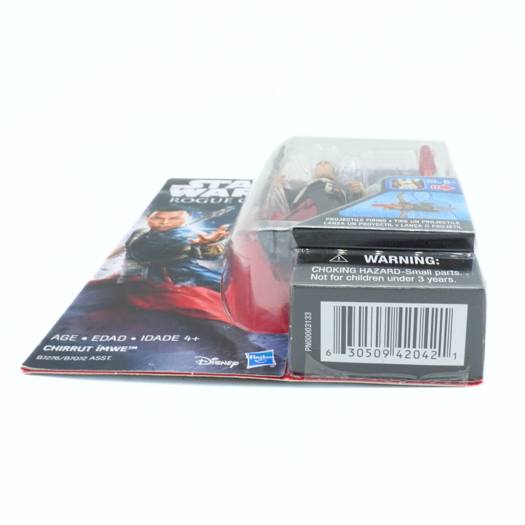Toy figure packaging with warning label and branding on a white background