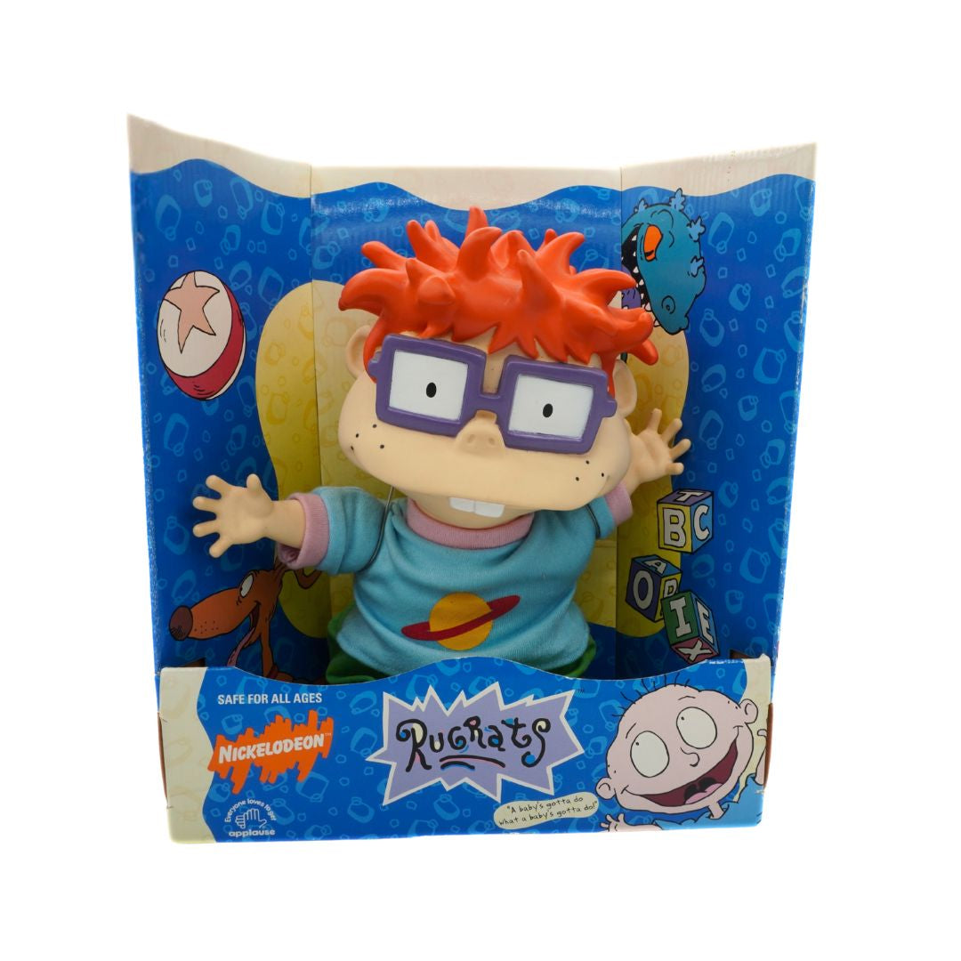 Toy figure of a character from 'Rugrats' in packaging with blue and beige design