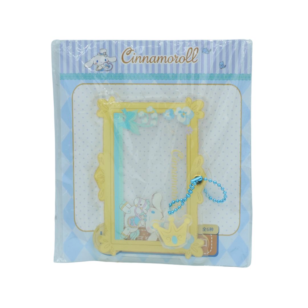 Blue and yellow clear frame charm in packaging on a white background
