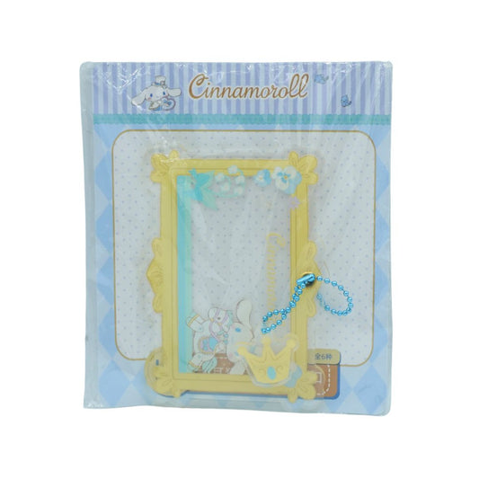 Blue and yellow clear frame charm in packaging on a white background