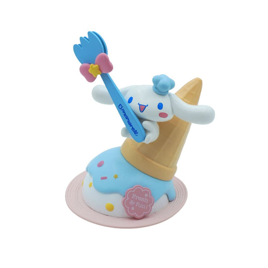 The Sanrio character Cinnamoroll against an icecream cone and holding a blue fork, photographed against a white background