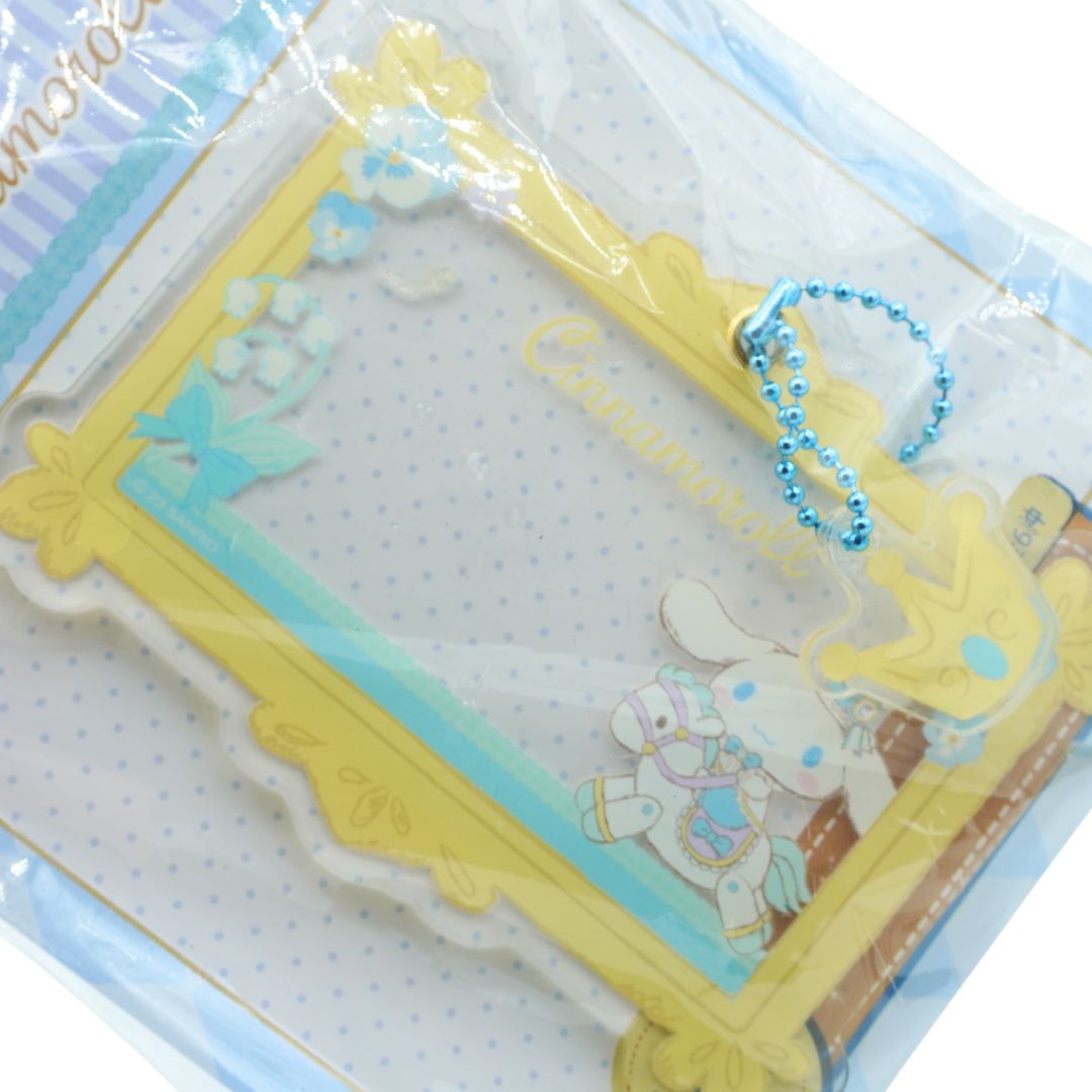 Blue and yellow clear frame charm in packaging on a white background