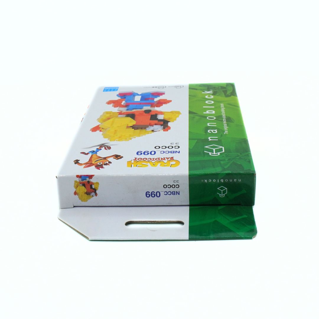 Nanoblock Coco box, featuring a white and green design with colorful toy vehicle illustrations, shown on a plain white background.