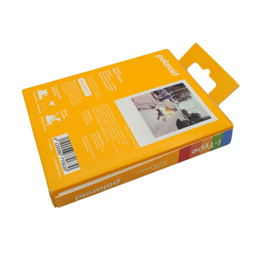 Polaroid i-Type instant film packaging box shown from the back, featuring a bright orange design with product details, a barcode, and a sample instant photo print on a white background.