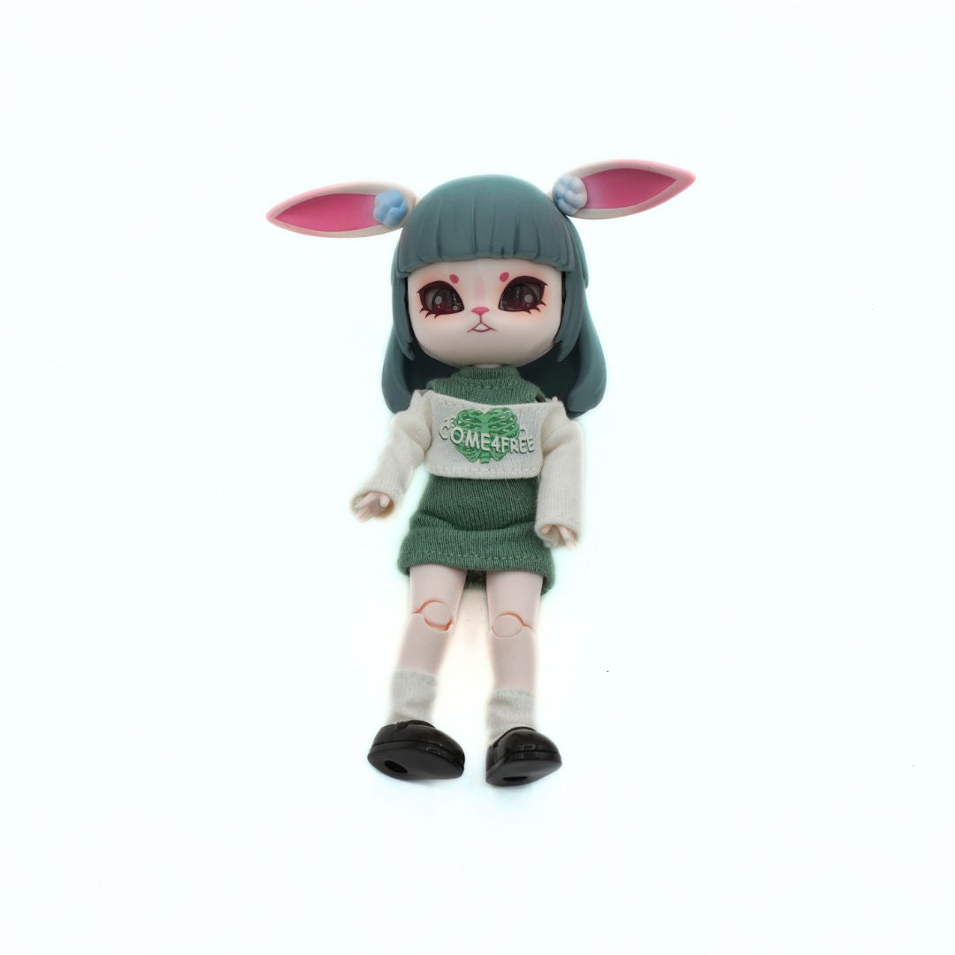 A stylized doll with dark green hair, pink bunny ears, and a green-and-white outfit, standing against a plain white background.