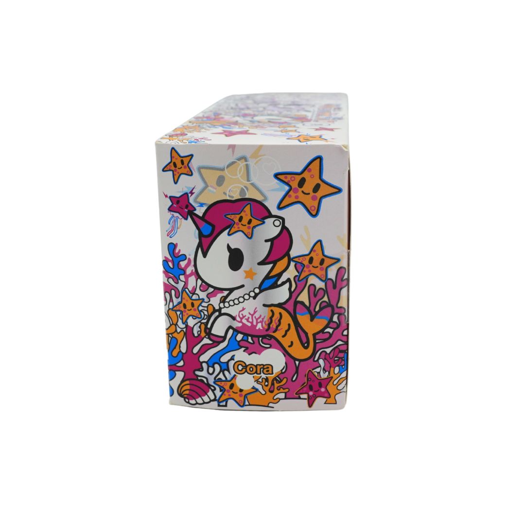 Photo of a colourful Mermicorno Tokidoki box with a set of two purple and white vinyl figurines