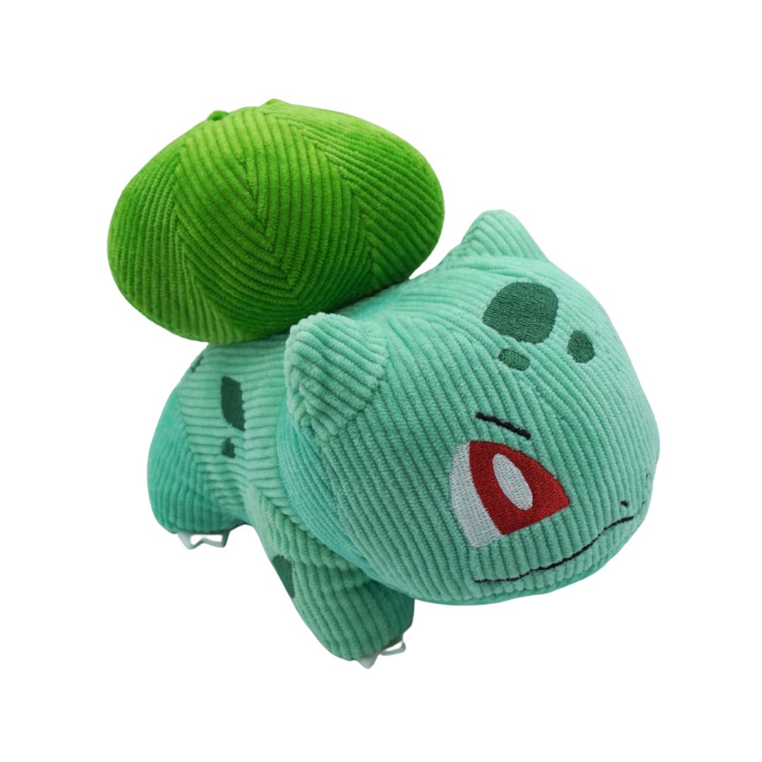 Green plush toy resembling a character from a popular animated series on a white background