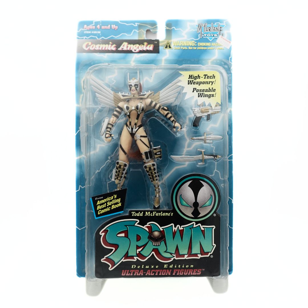 Cosmic Angela action figure from Spawn, wearing a black, silver and gold outfit inside its packaging