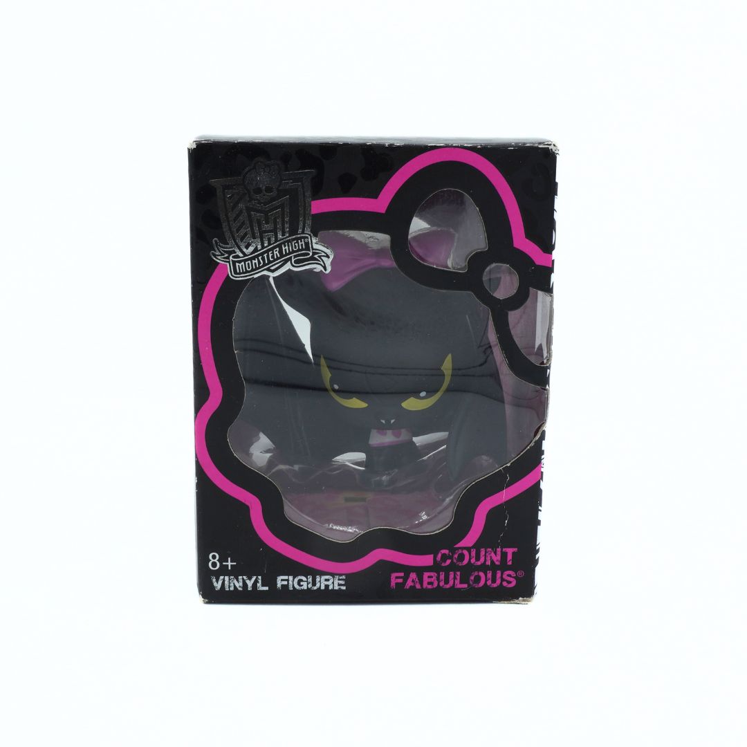 Black cat toy with yellow eyes inside a black and pink box