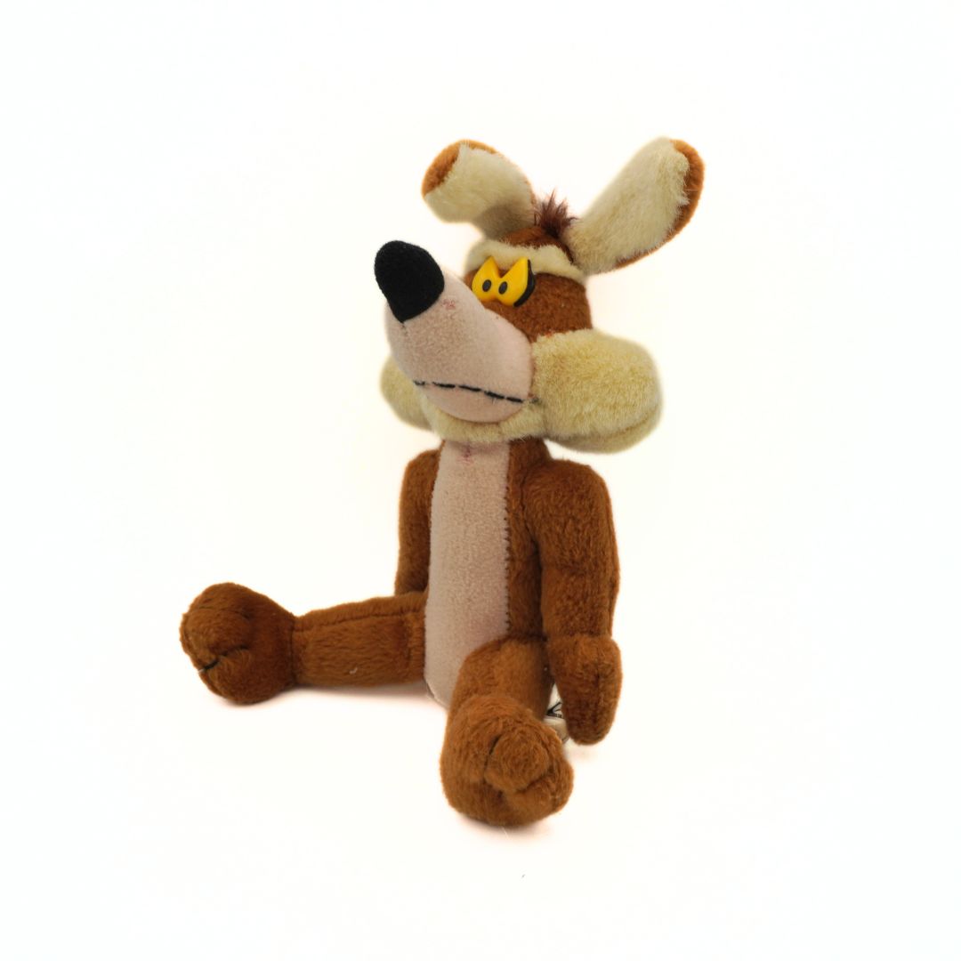 Plush toy resembling a cartoon character with brown fur and a white muzzle on a white background