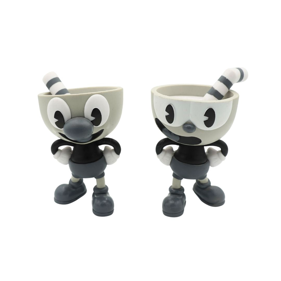 Two small character figurines resembling Cuphead, shown side by side on a plain white background.