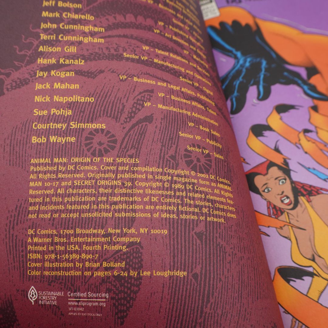 Close-up of a printed book cover or comic book page showing character art on the right and extensive copyright credits and publisher text on the left. Visible text includes Jeff Bozel, Mark Chiarell, Terci Cunningham, Hank Gili, and DC Comics / Animal Man: Origin of the Species.