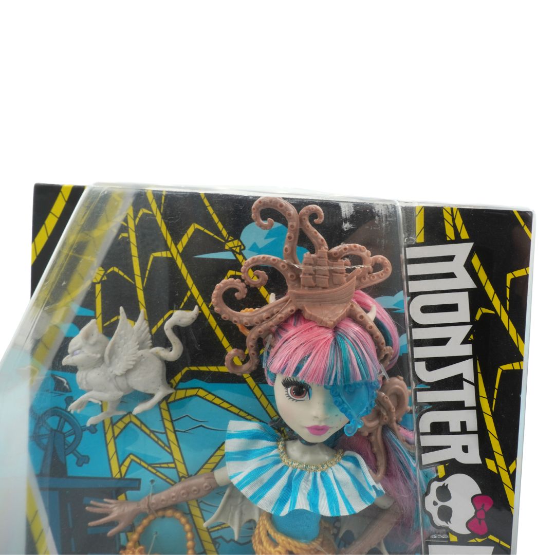 Toy figure with blue hair and a pink headpiece in packaging with 'Monster' branding.
