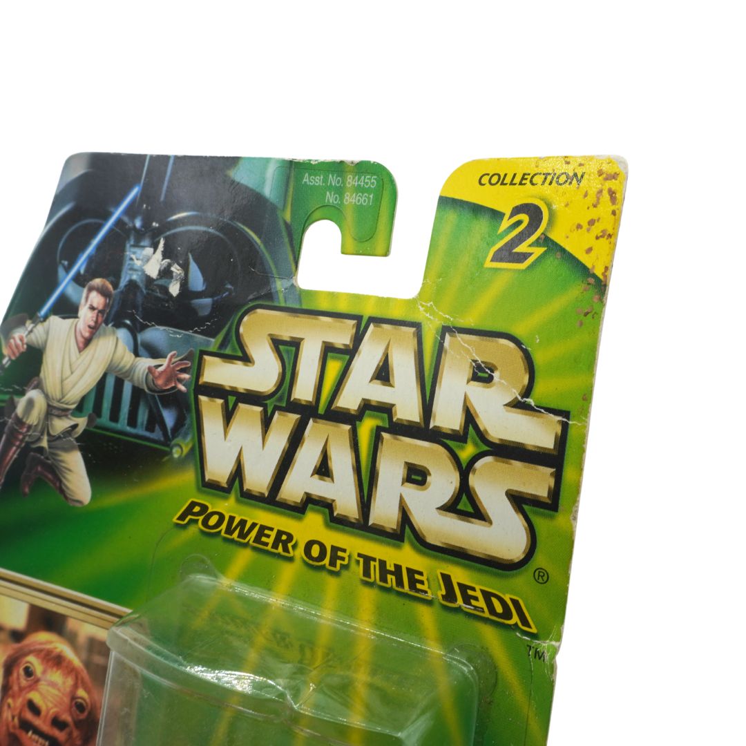 Star Wars toy figure packaging with characters and 'Power of the Jedi' text on a green background