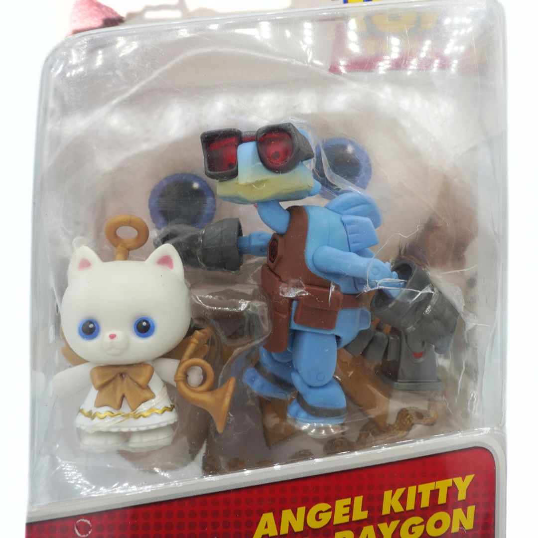Toy figure set with a blue robot and white cat-like creature in packaging, featuring 'Angel Kitty' and 'Raygon'.