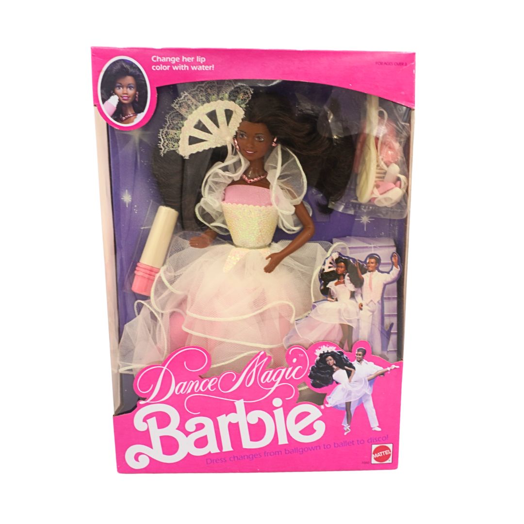 Barbie doll in white dress with packaging on a white background