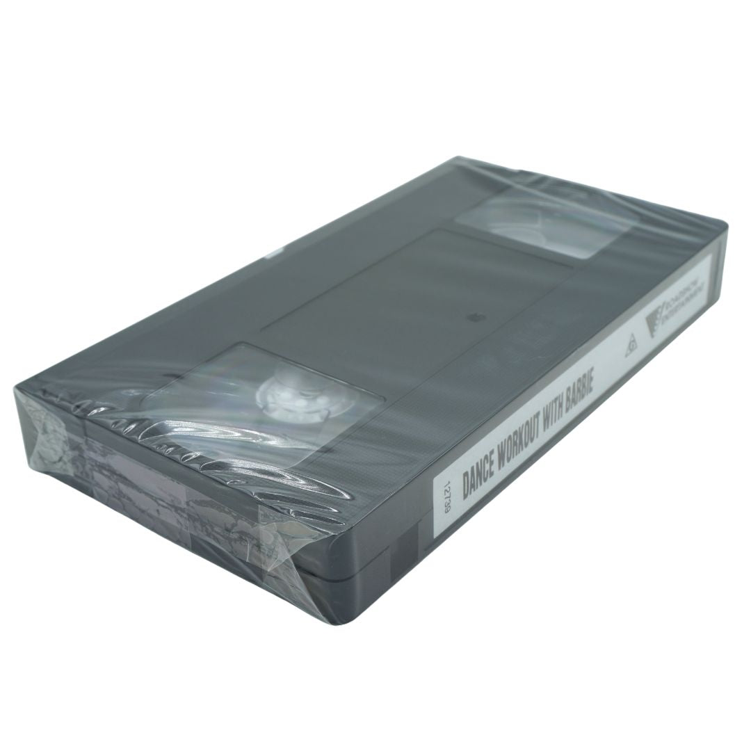 A black VHS tape for Dance Workout with Barbie, still in its original plastic packaging