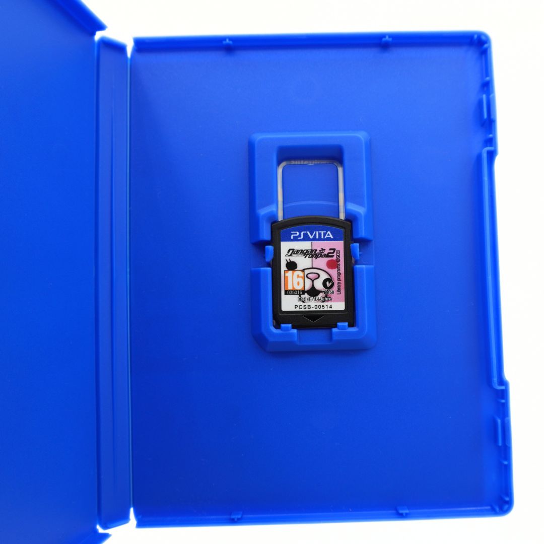 A PS Vita game cartridge, shown inside a blue plastic case on a white background.