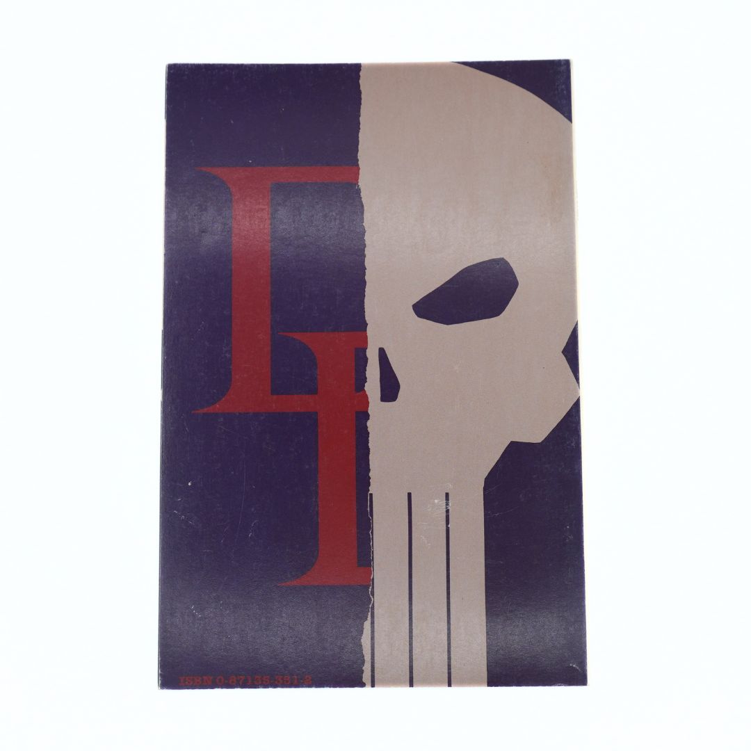 A rectangular art print or poster featuring a stylized split design: a dark navy background on the left with a large red letterform, and a beige skull motif on the right. The print is photographed against a plain white background.